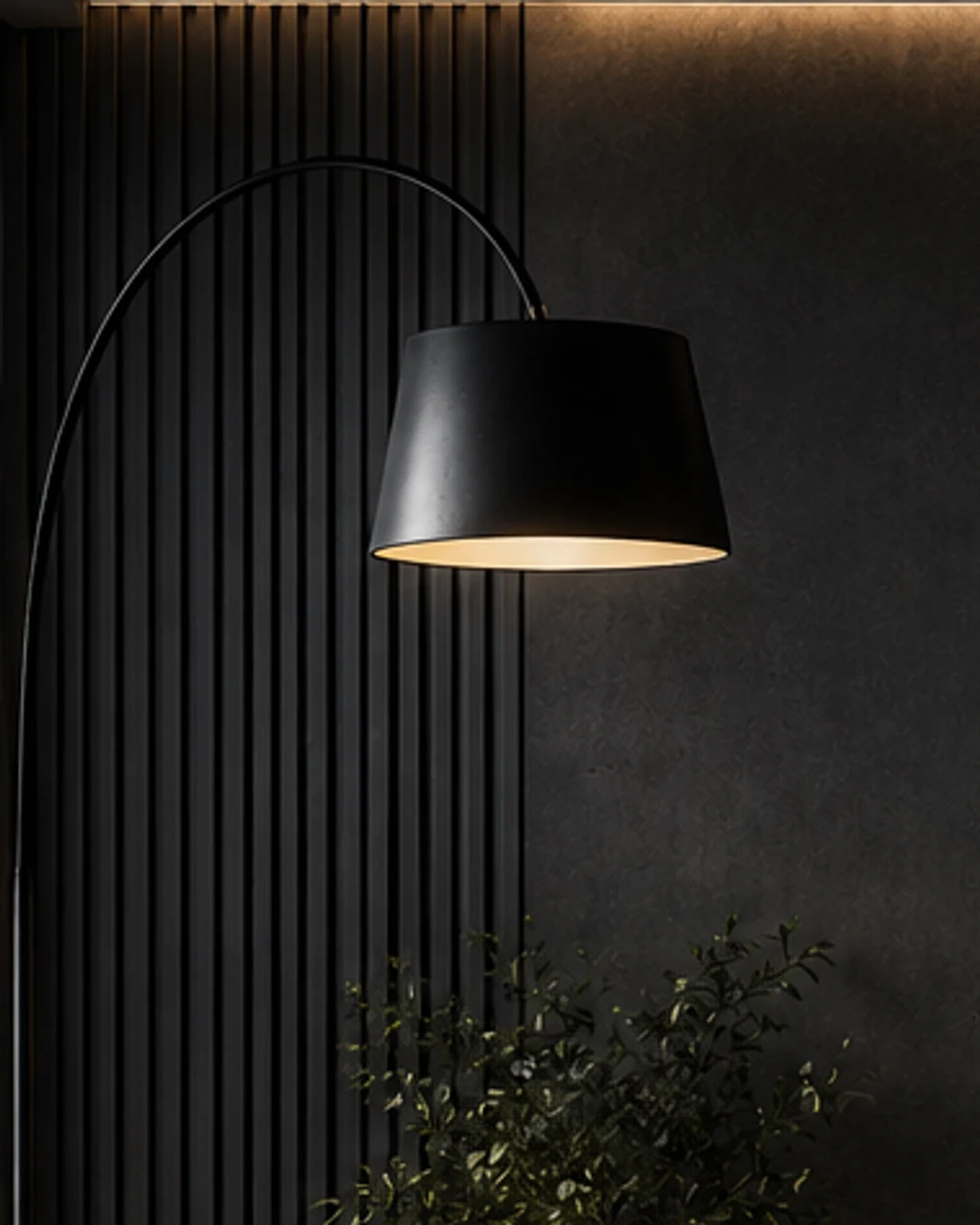 A black arc floor lamp with a wide drum shade curving over a fluted timber wall.